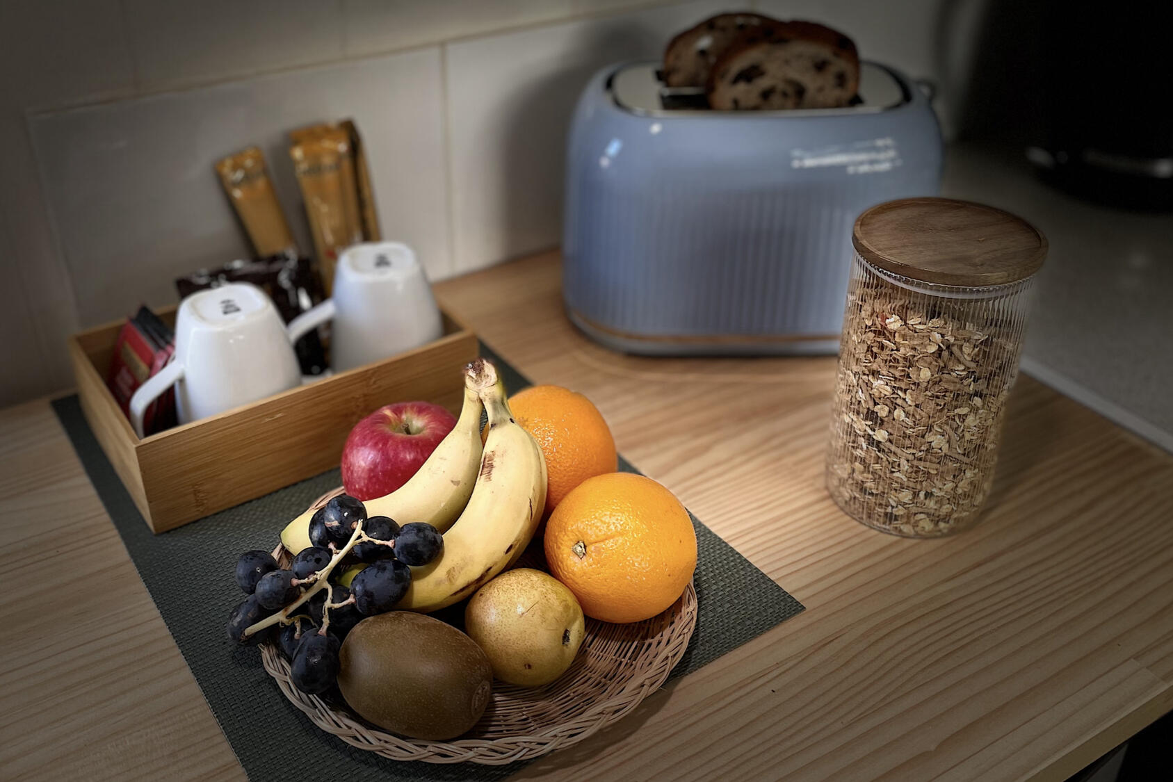 A continental breakfast, cereal, toast, fruit, coffee and tea.