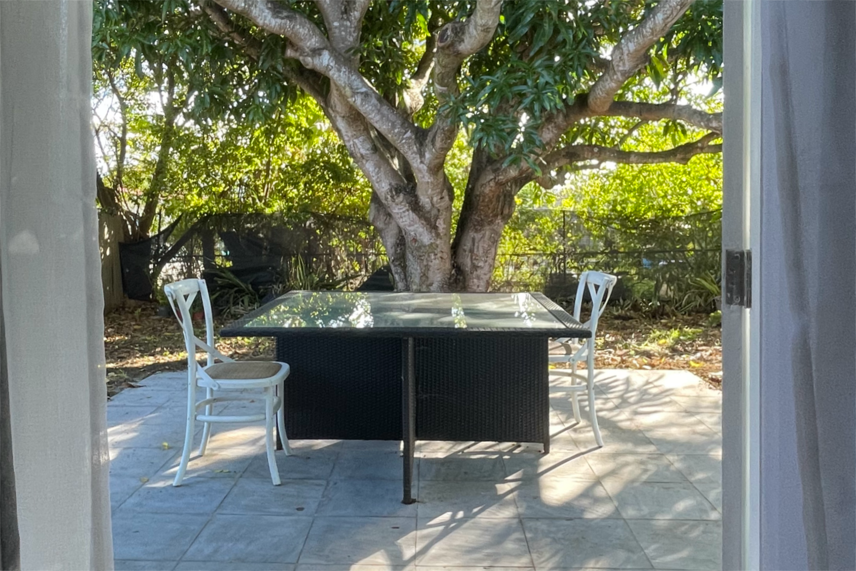 Enjoy the patio under our mango tree.