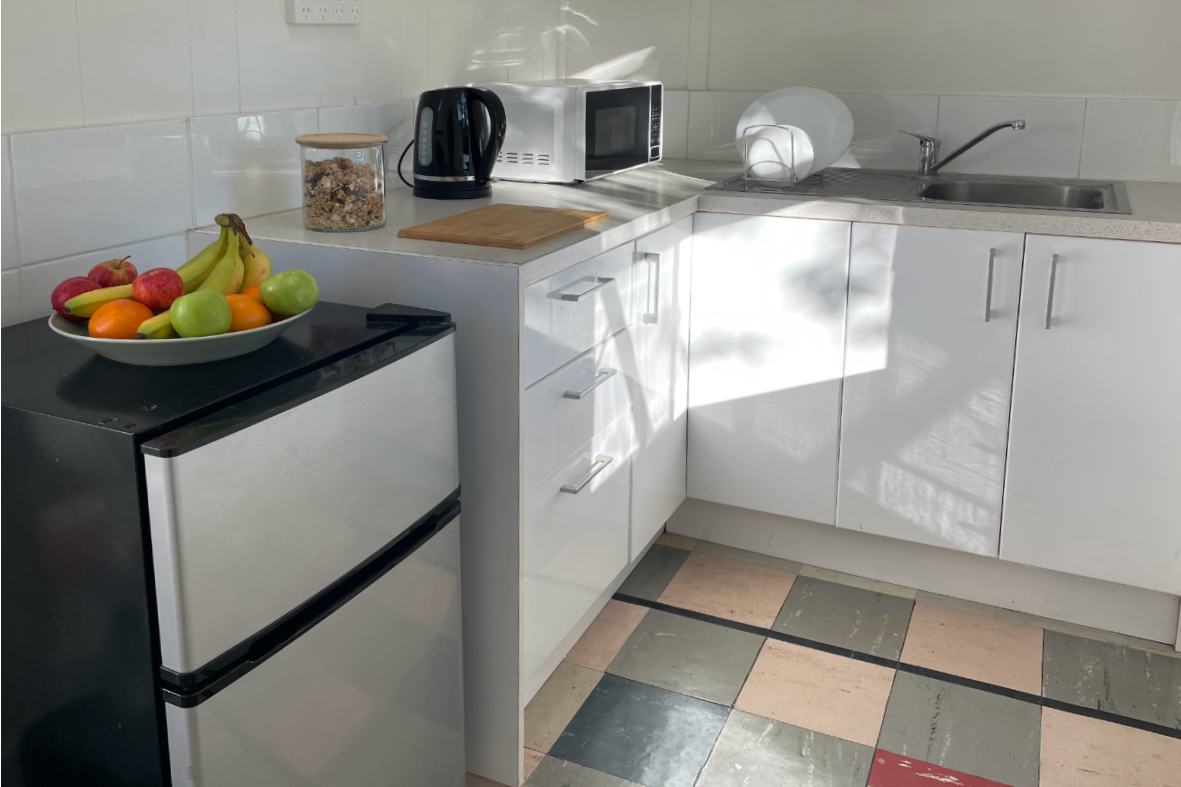 A separate kitchen equipped with all you need to cook at home.